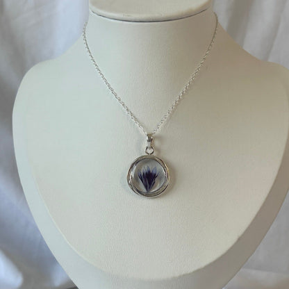 Necklace with a pendant on a white mannequin bust against a white background